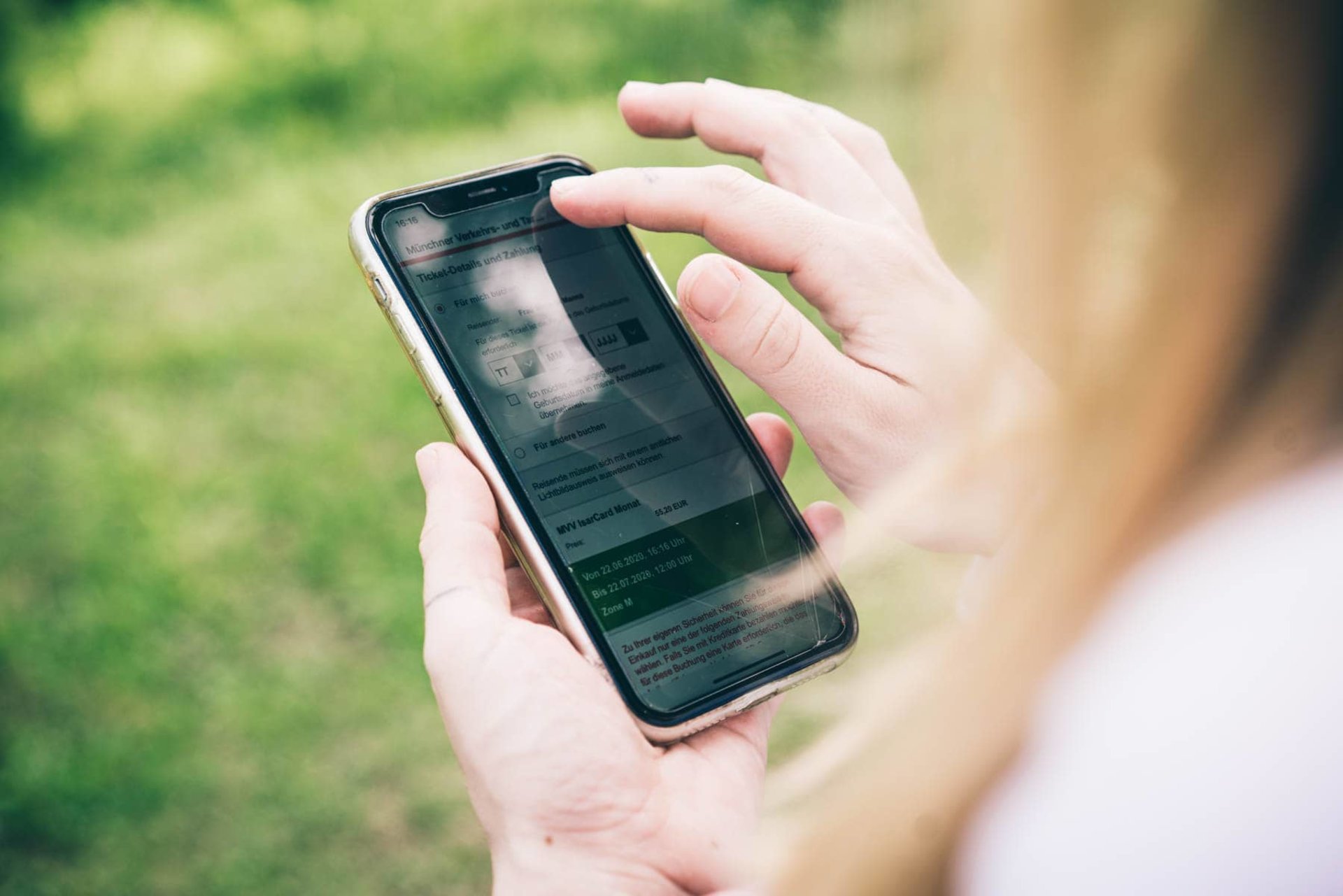 Person nutzt die München Navigator App auf ihrem Smartphone